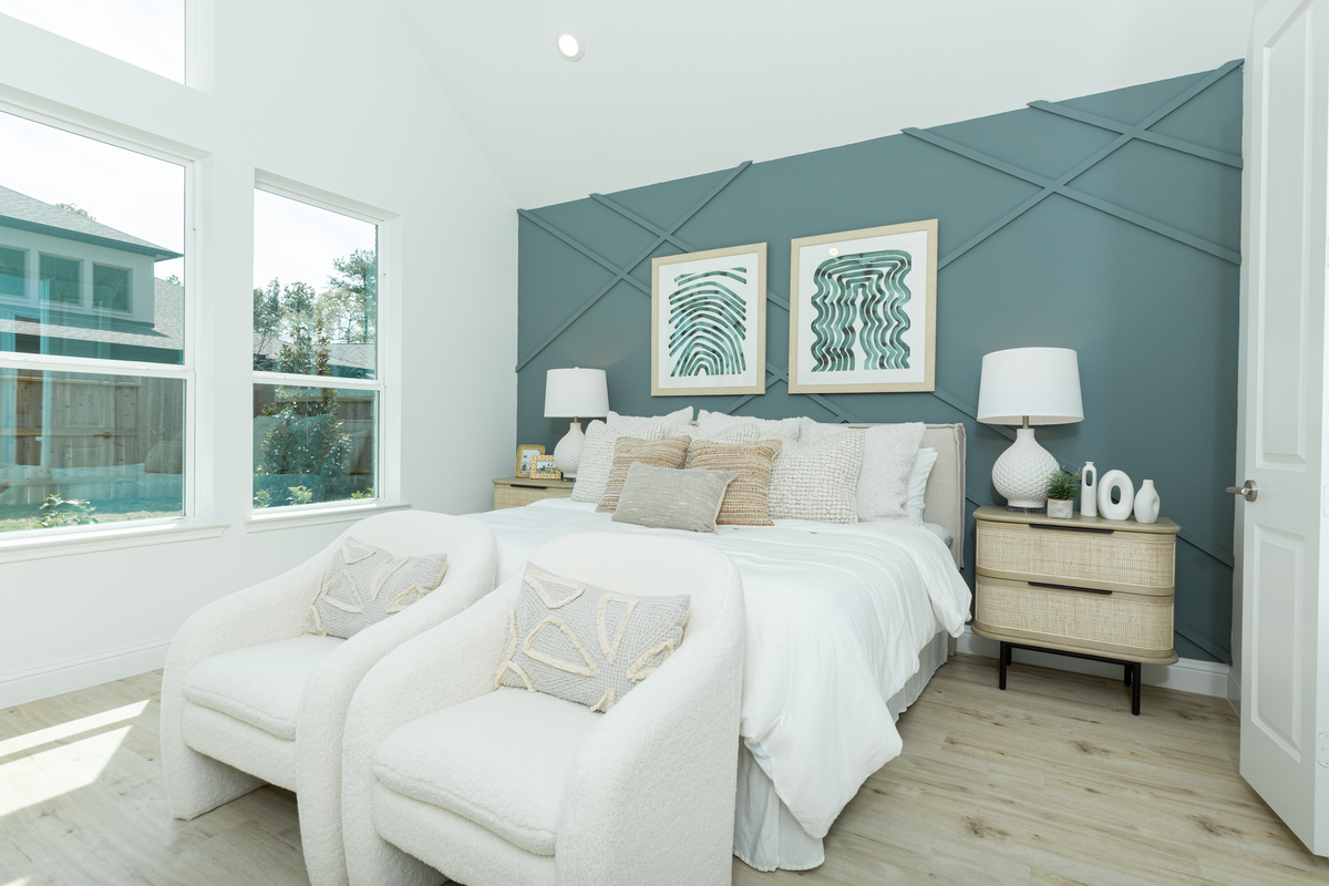 bedroom with high ceiling and large windows