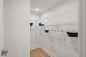 large walk-in pantry with built in wire shelves