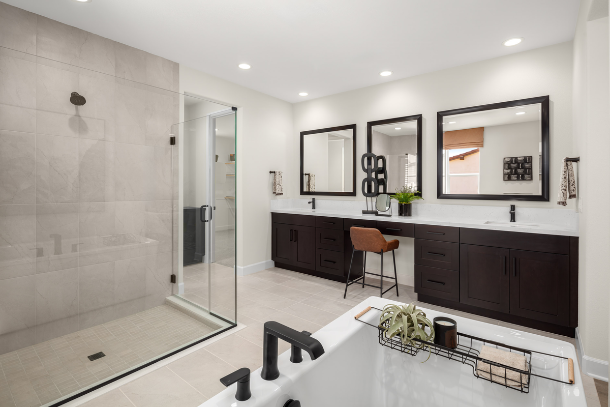 primary bathroom with tile floor and dark cabinets