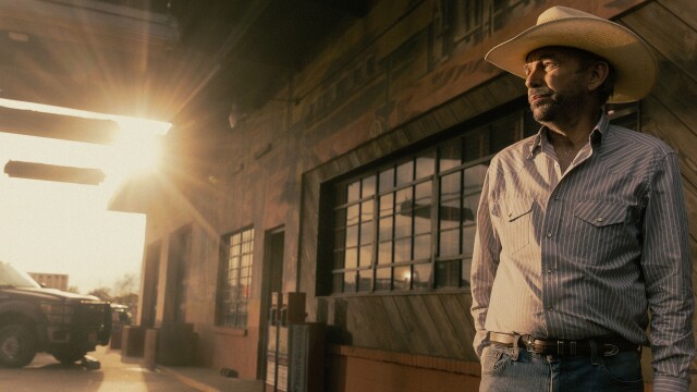 Billy Bob Thornton as Tommy Norris standing outside a West Texas bar at sunset in Landman