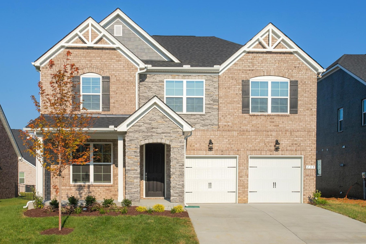 brick and stone home exterior with 2-car garage