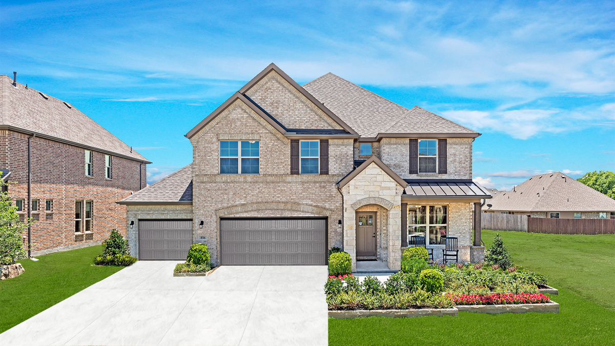 brick and stone exterior with lush landscaping