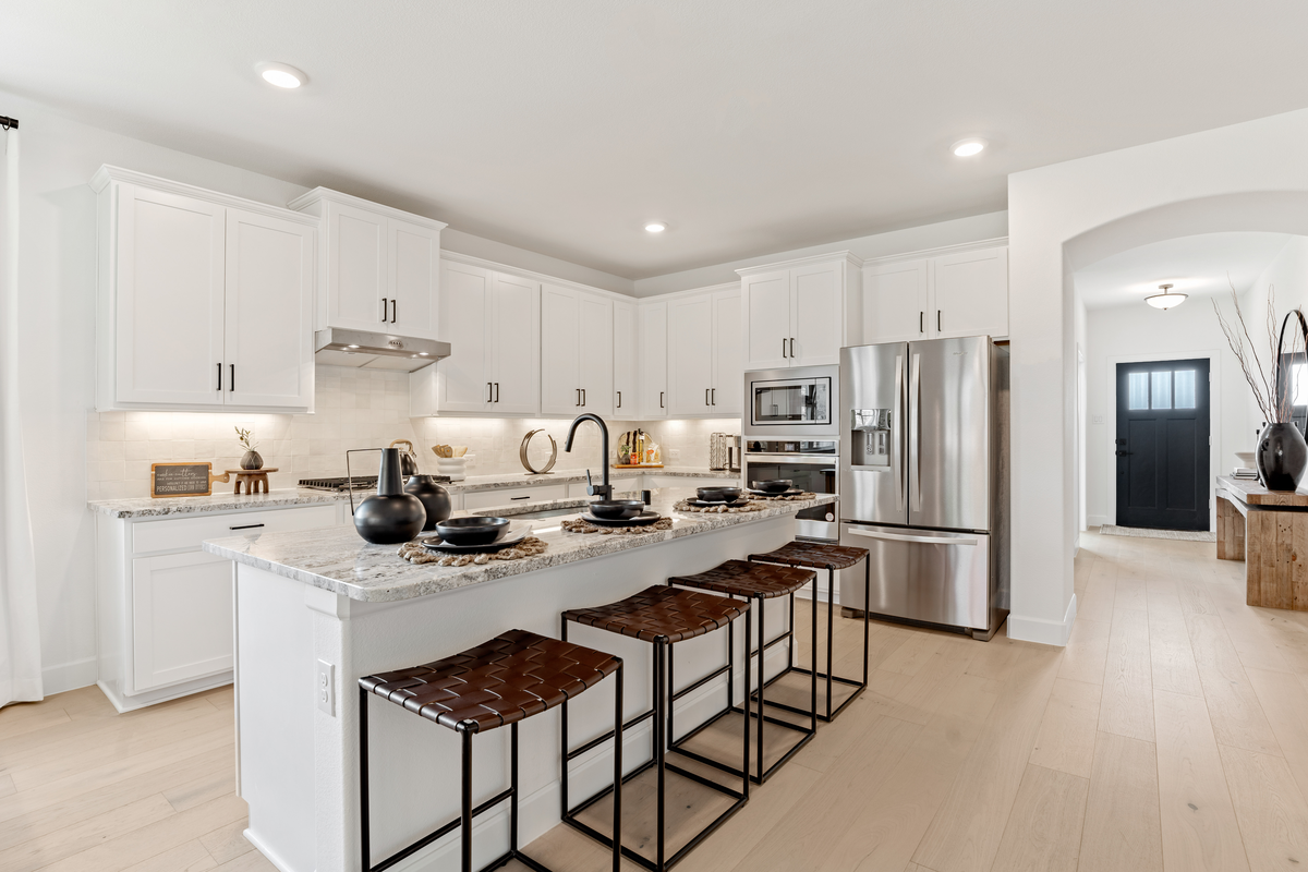 open kitchen with white cabinets and wood floors