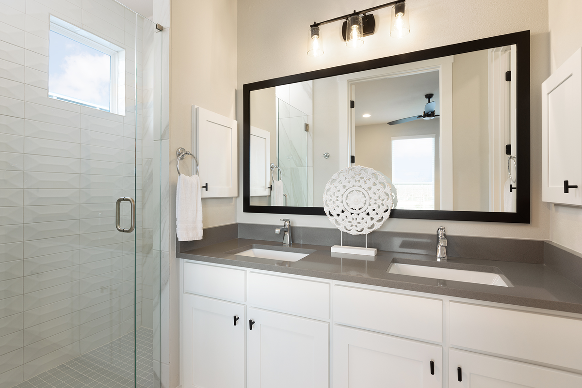 bathroom with granite countertops & white cabinets