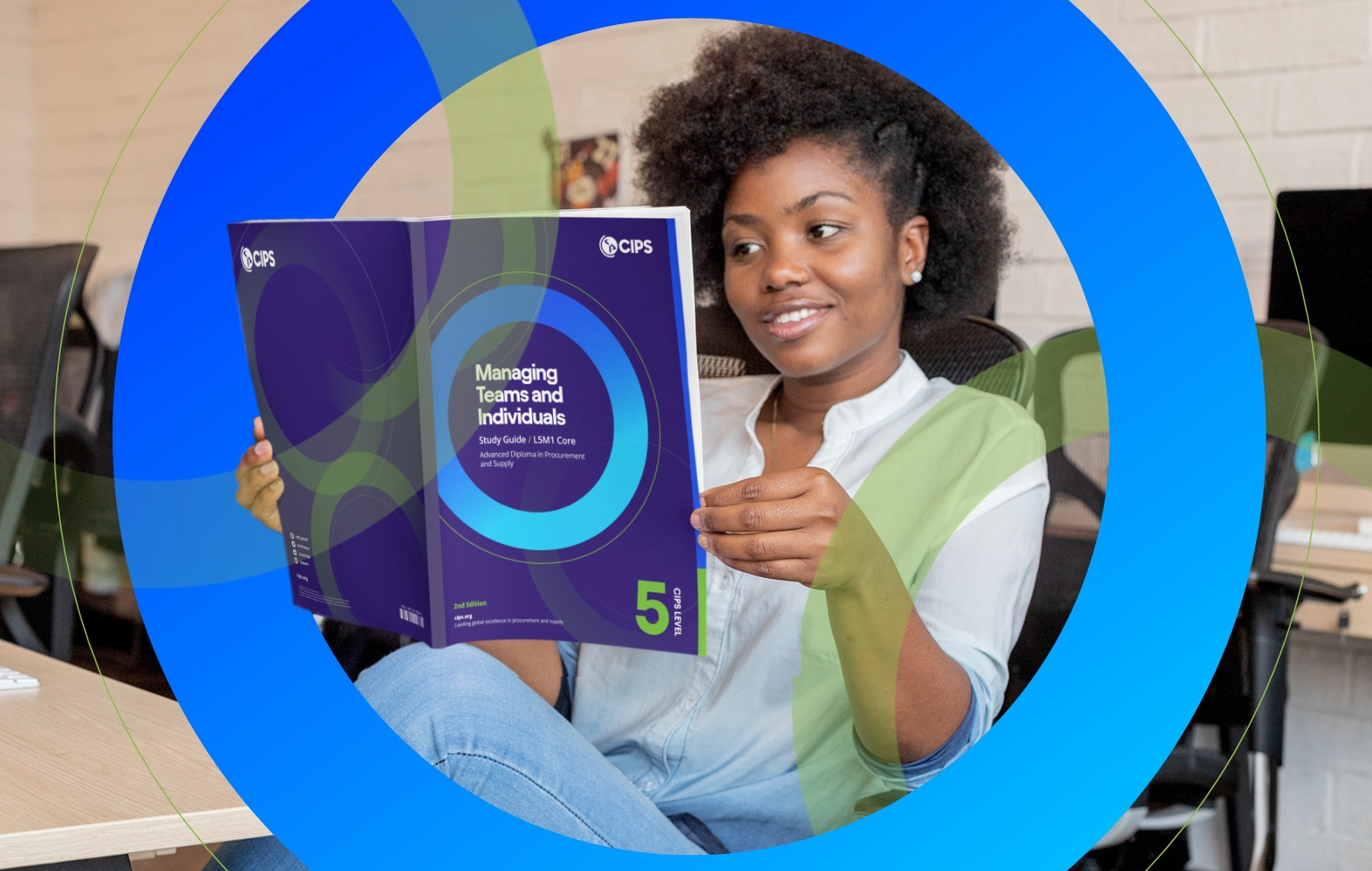 Smiling young woman sitting at a desk, reading a CIPS Level 5 study guide