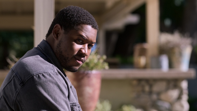 Luke Tennie as Sean sitting outside in the sun in Shrinking