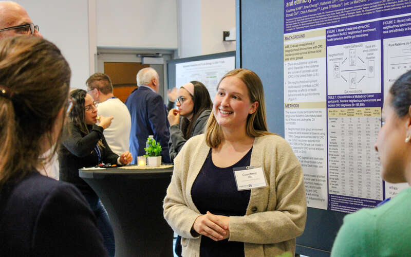 Participant smiles during poster presentation