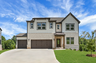 front of 2-story home with 3-car garage and light brick