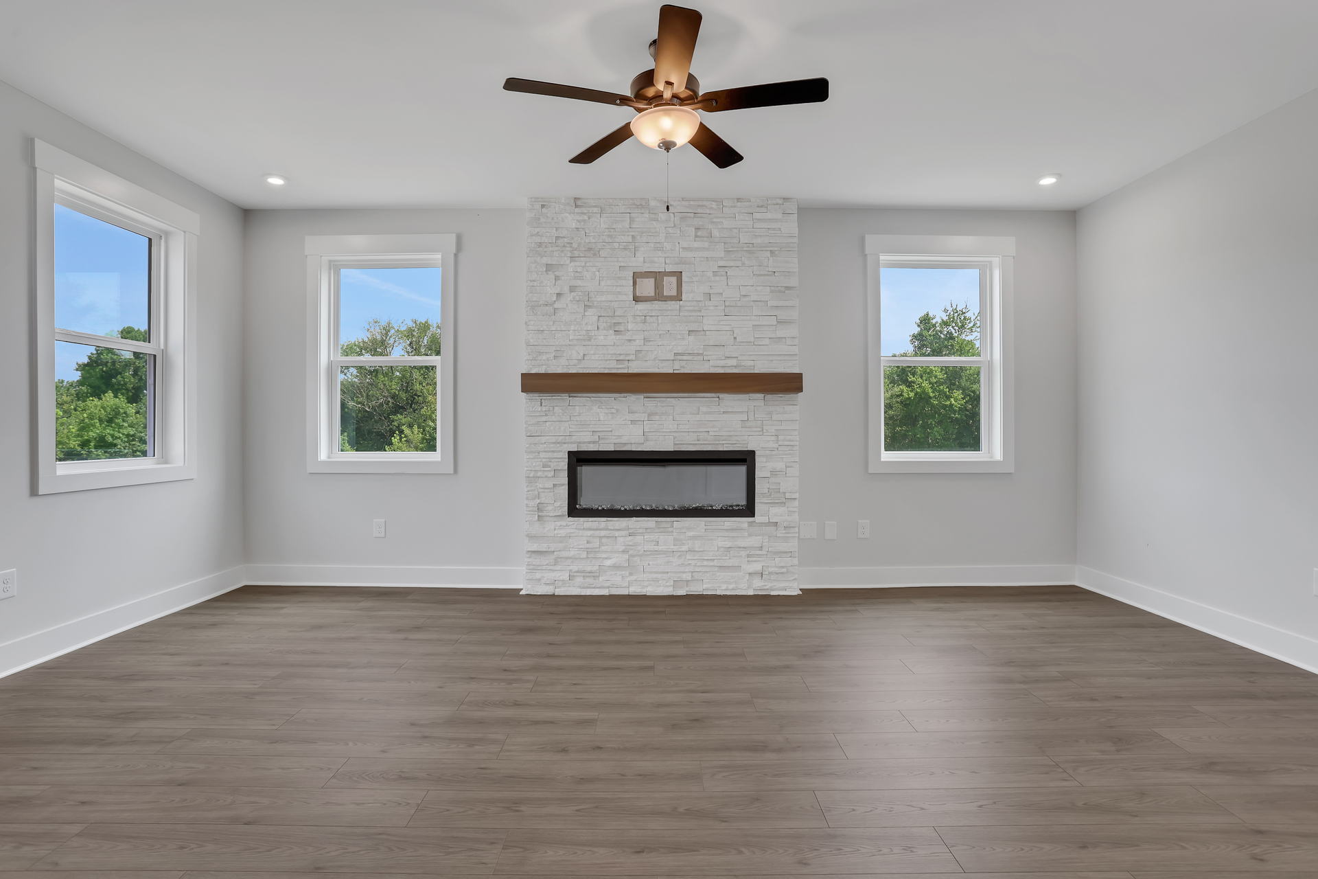 great room with electric fireplace and hard surface flooring