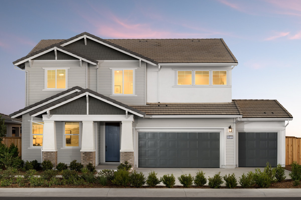 front of gray & white home with blue door