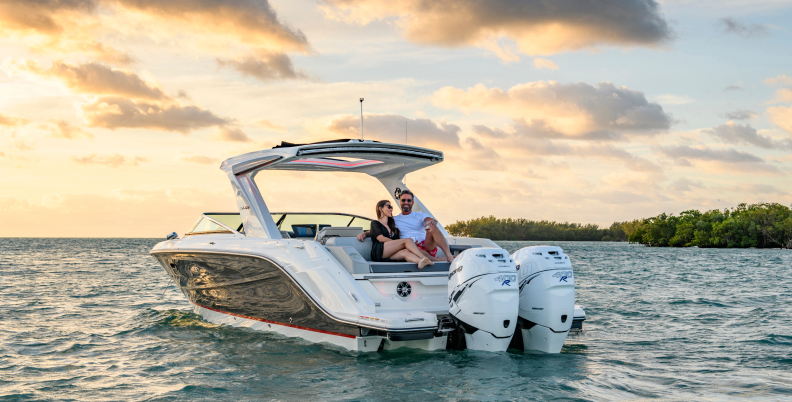 Couple seated at stern of powerboat with onboard Fathom e-power system