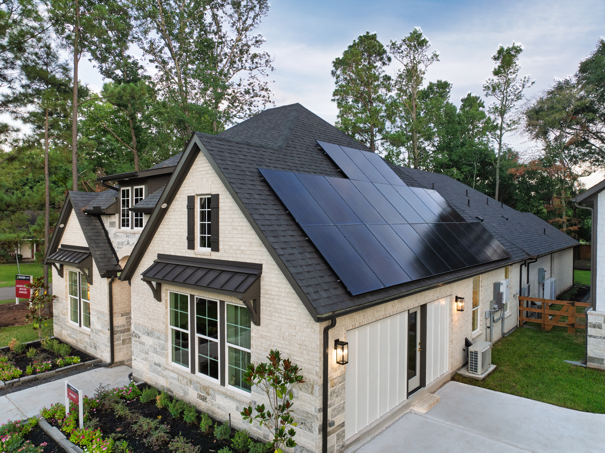 exterior brick home with solar panels on roof