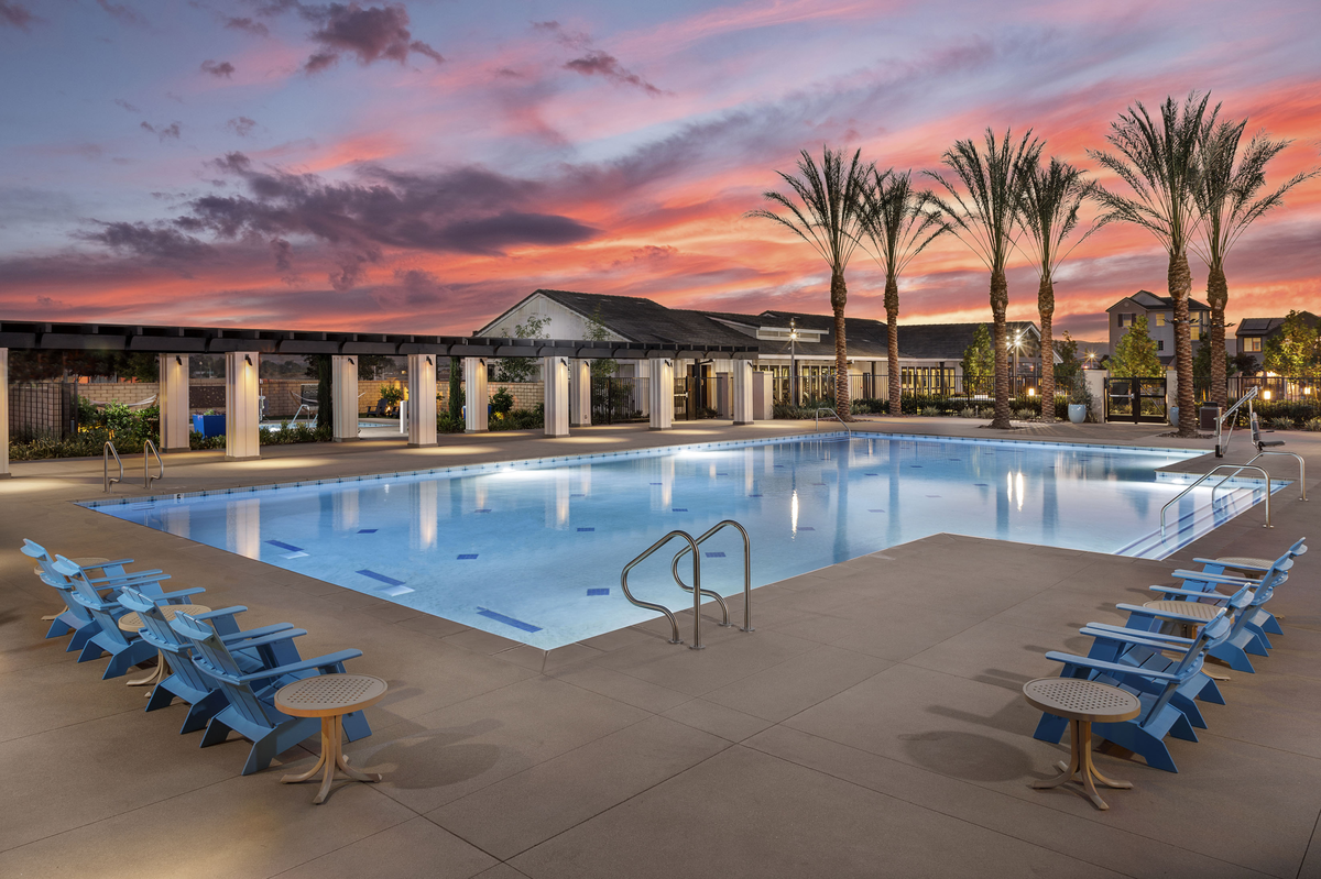 large pool with chairs and table around it 