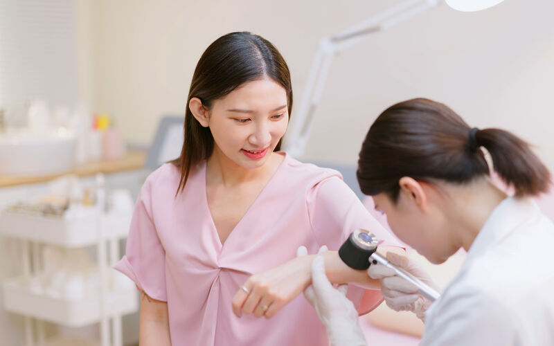 A woman is screened for skin cancer.