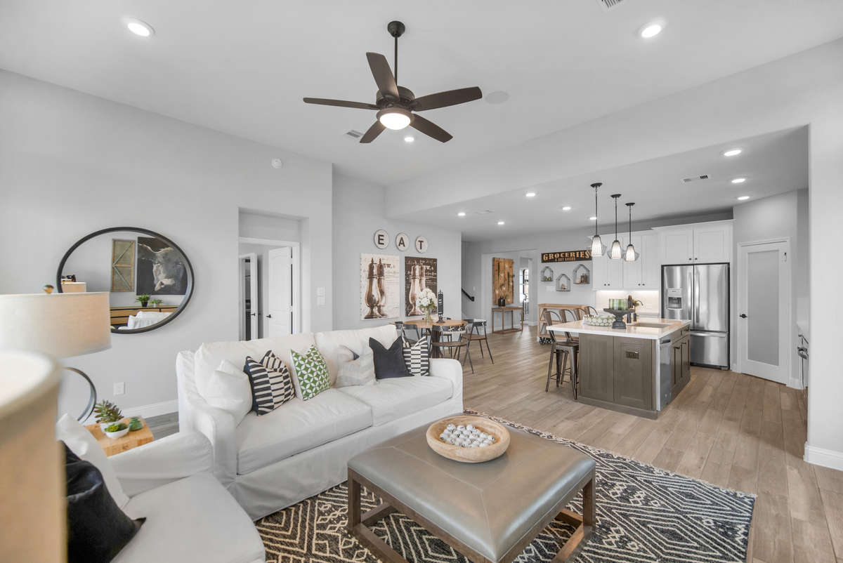 great room with wood-like tile and ceiling fan