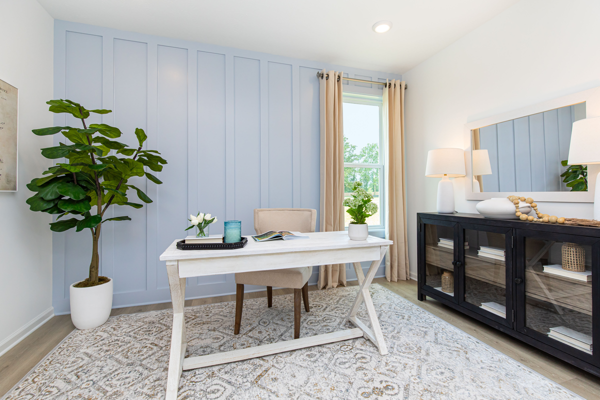 study with blue accent wall and desk