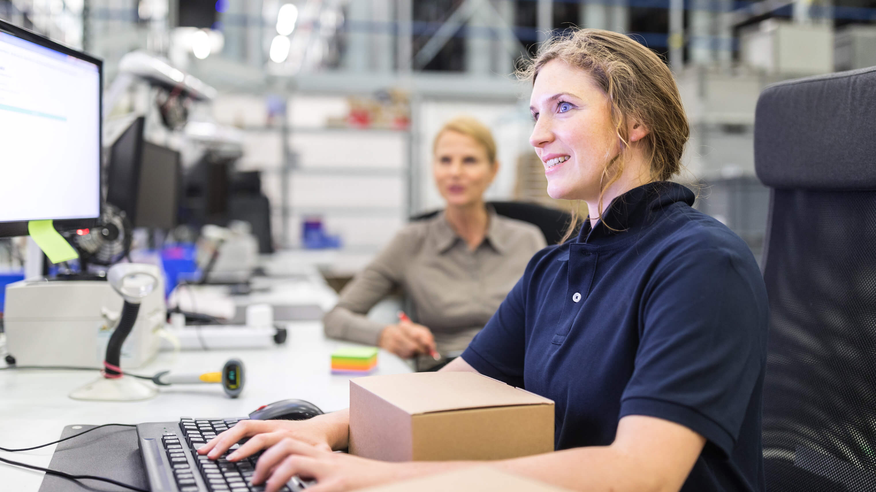 Image of a woman typing on a computer keyboard.