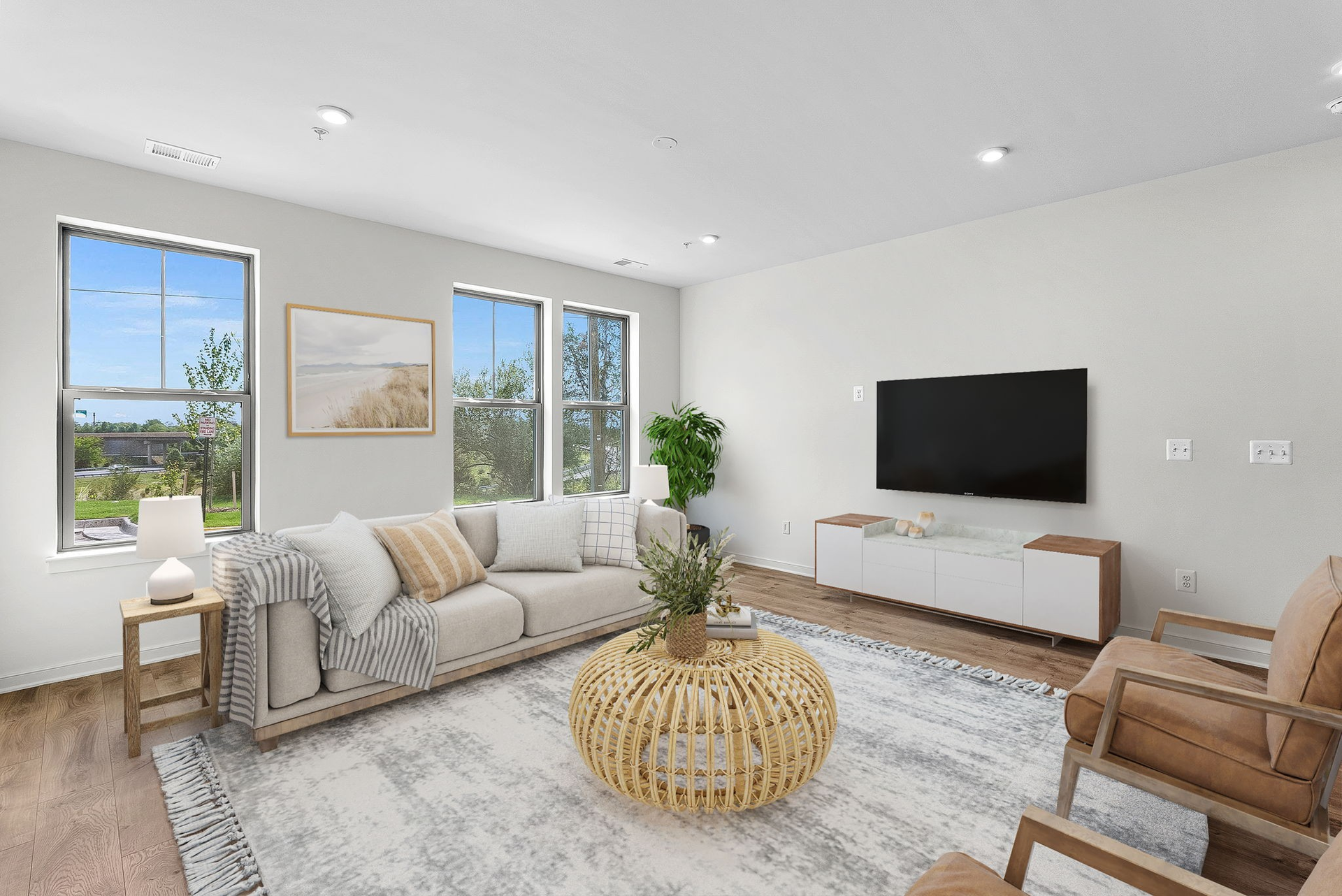 great room with three windows and furniture