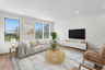 great room with three windows and furniture