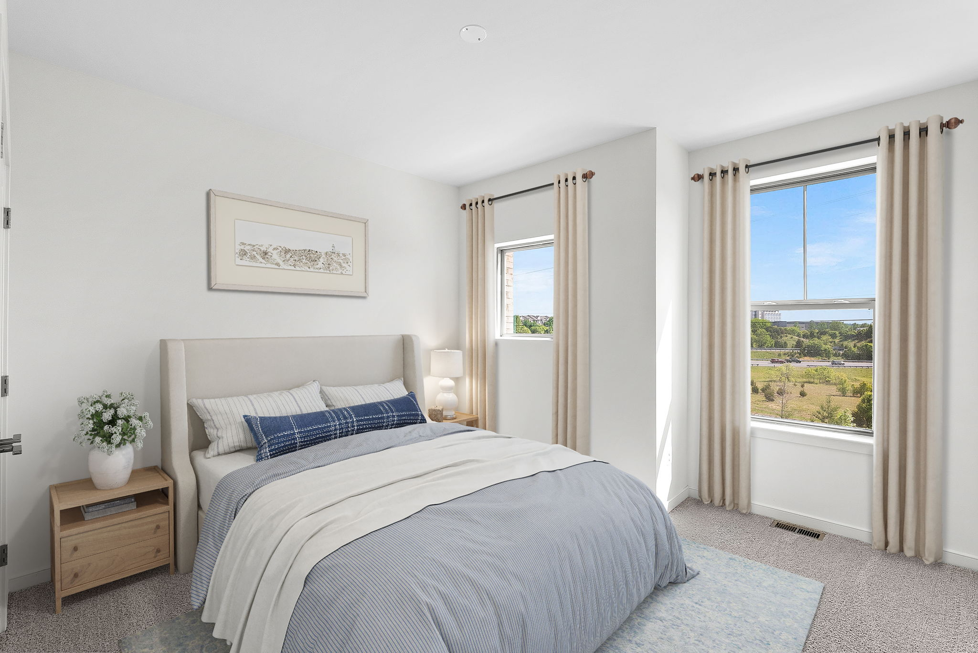 secondary bedroom with two windows and bed