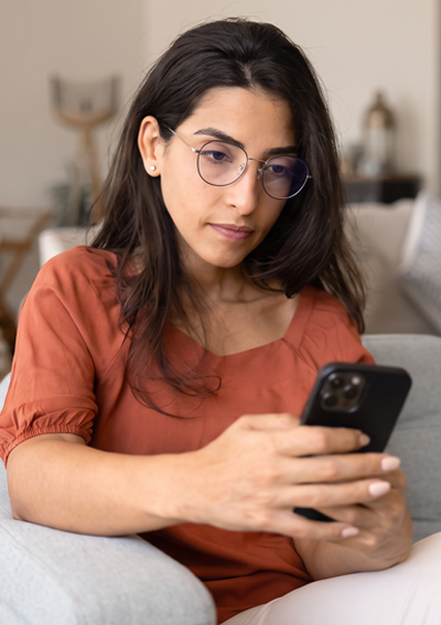 Woman on sofa looking at phone