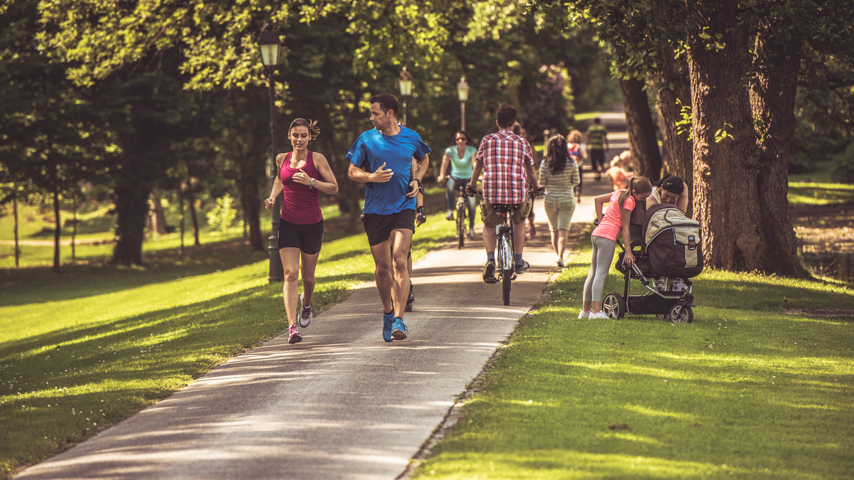 a couple running on a paved trail