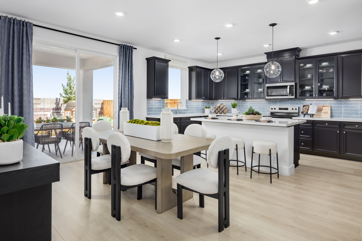 kitchen with light wood floors & black cabinets