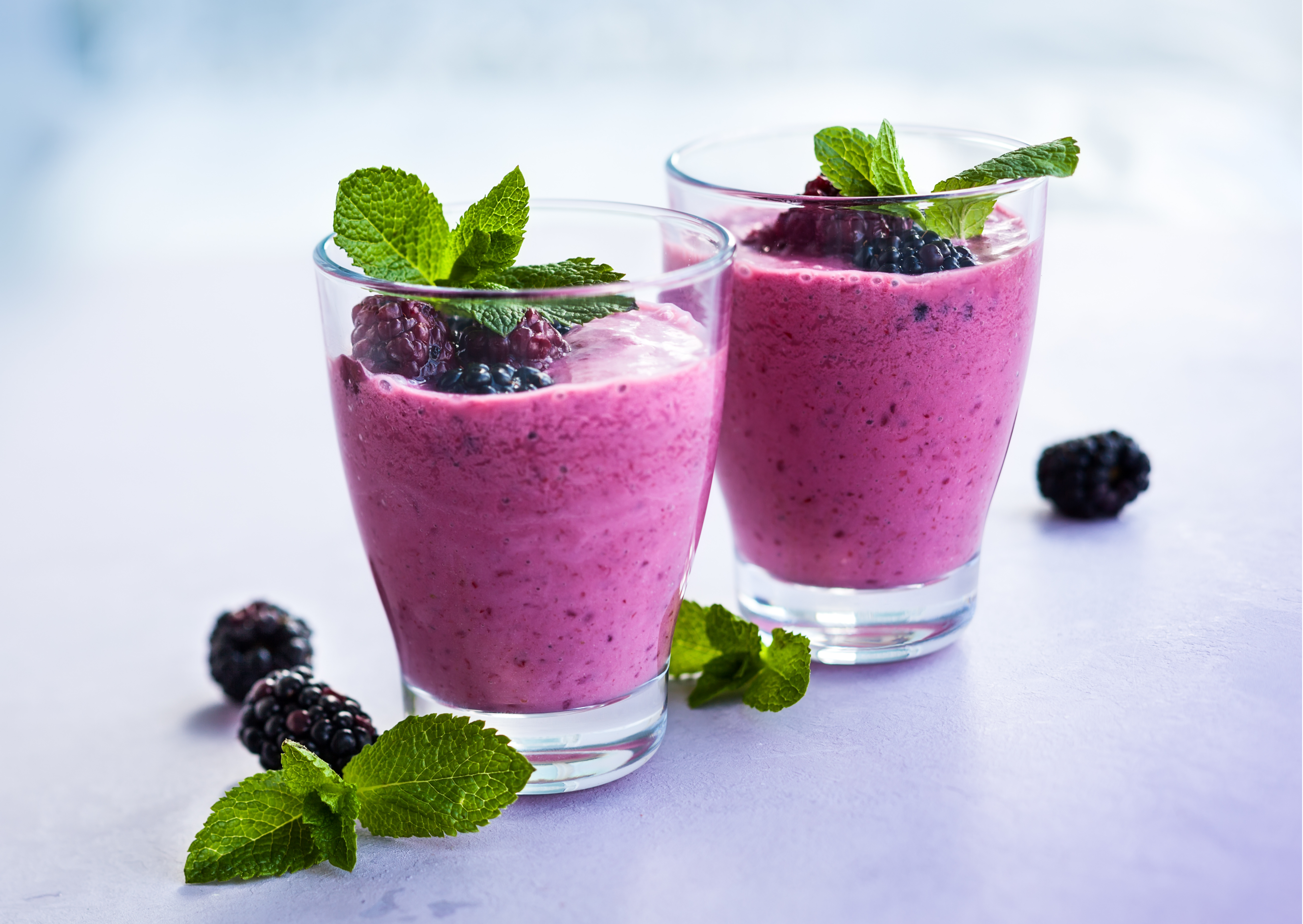 Nutrition Australia's Dairy Free Berry Delight Smoothie served in glass with fresh blueberry's 