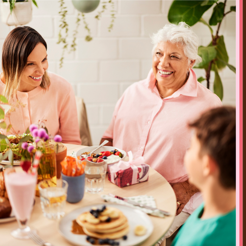 Mum, grandma and son laughing and enjoying Mothers Day brunch together