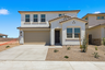 two-story single-family home with desert landscaping and concrete driveway