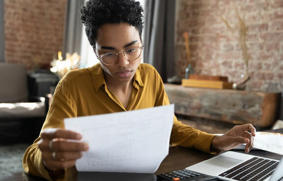 Focused financial planner studying paperwork