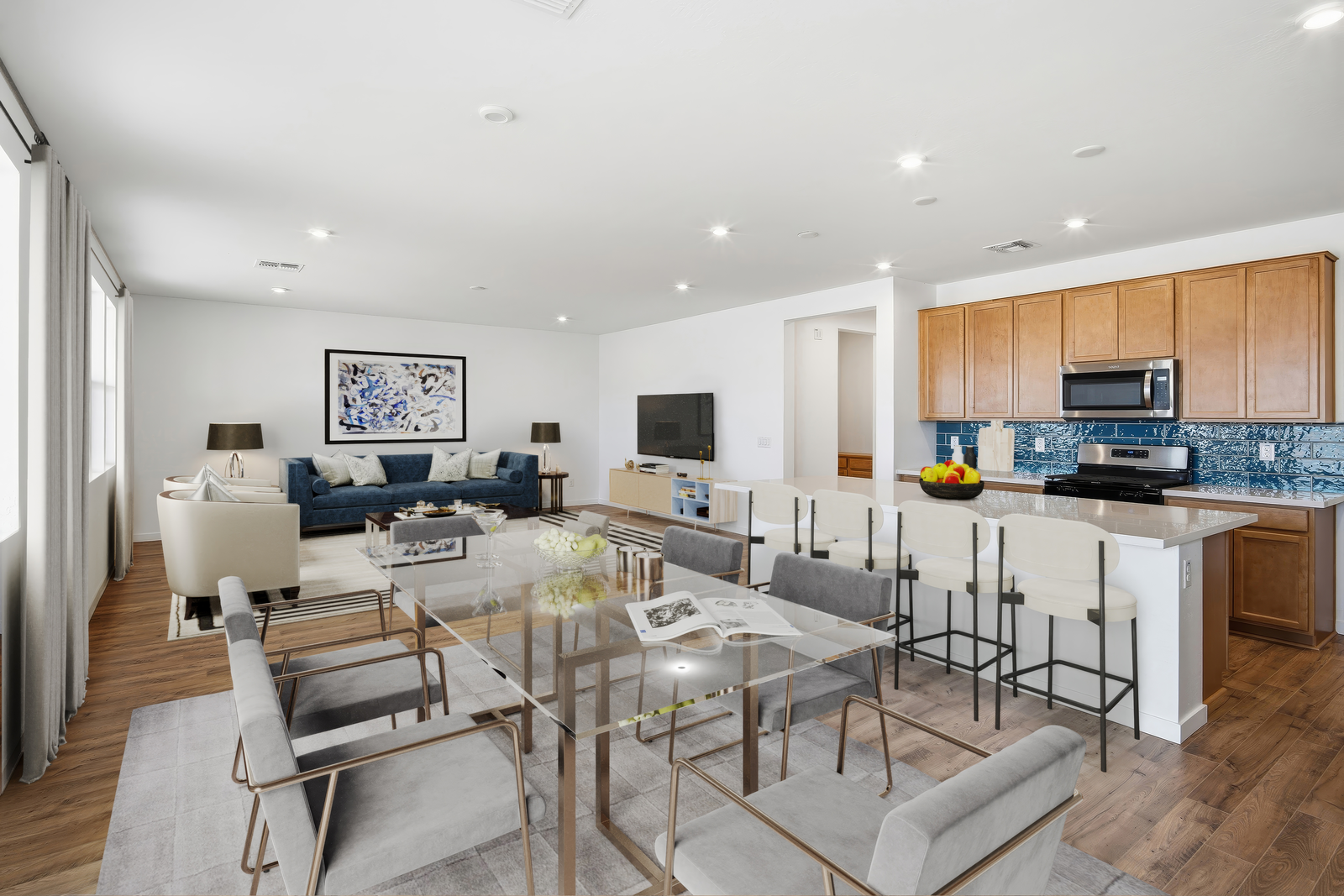 open-concept space with a glass dining table, grey chairs, and grey rug