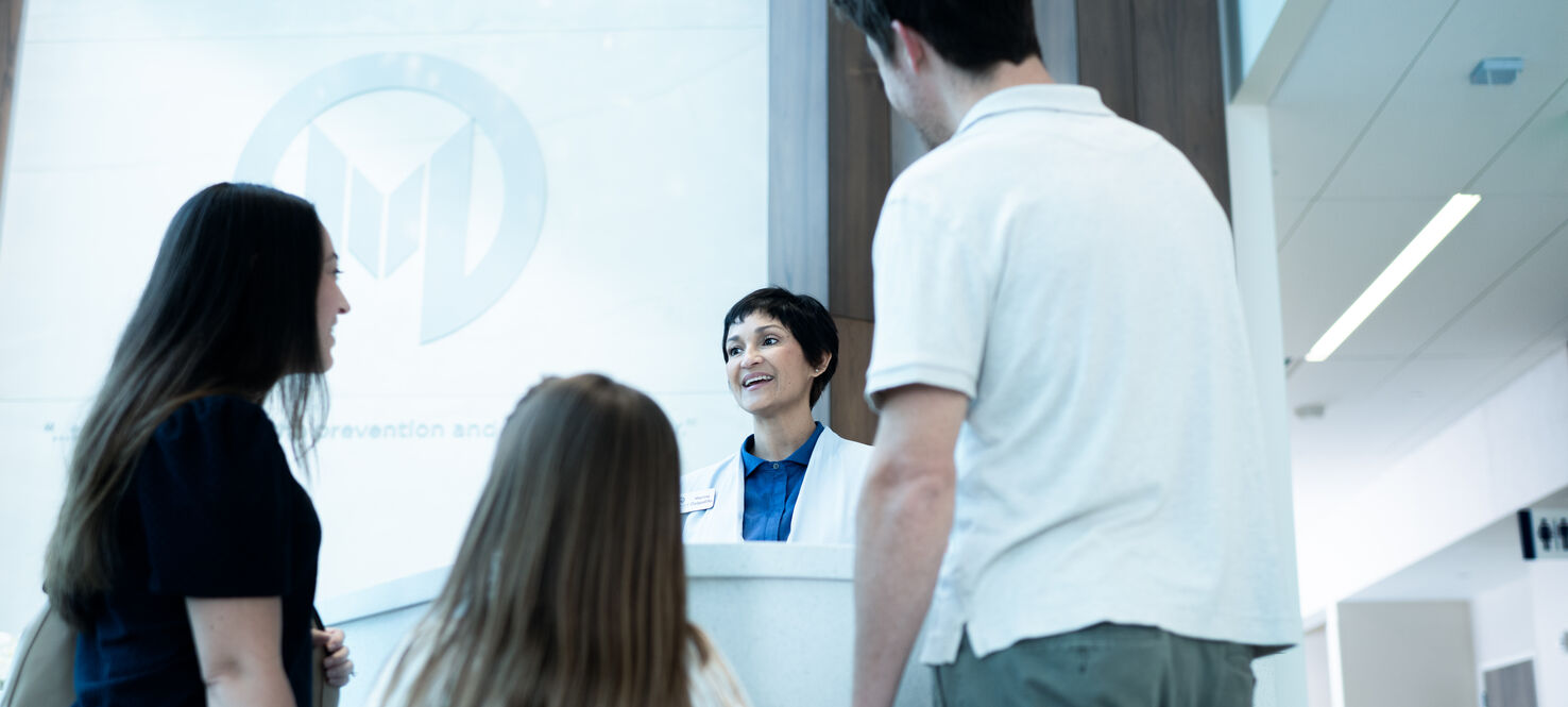 patient and family checking in at front desk