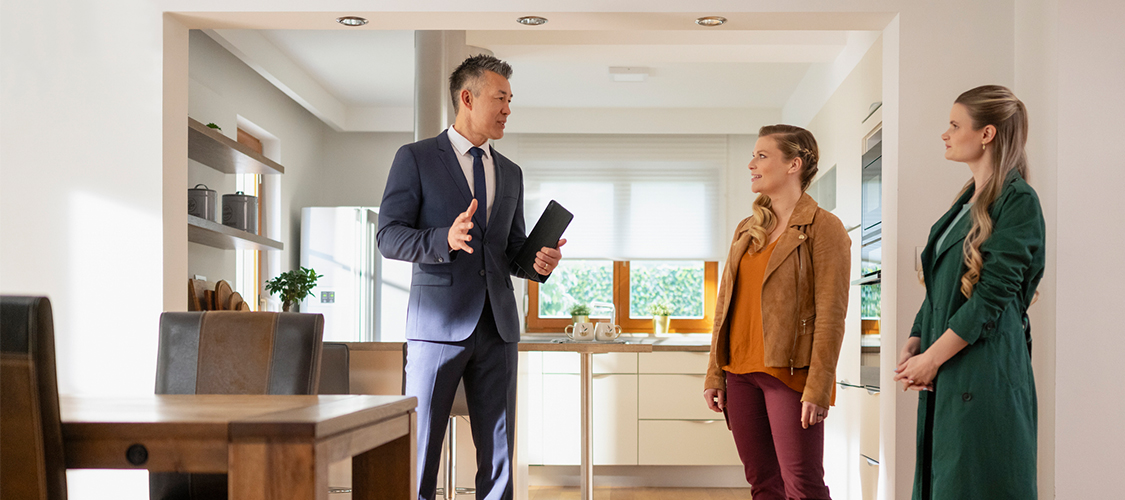 A real estate agent showing a home to a lesbian couple.