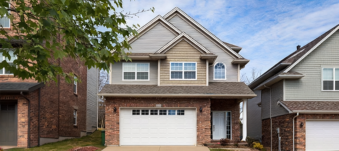 A shot of a cute, modest house taken outdoors.
