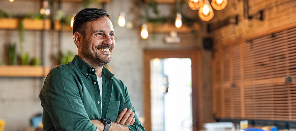 A smiling man in a green shirt.