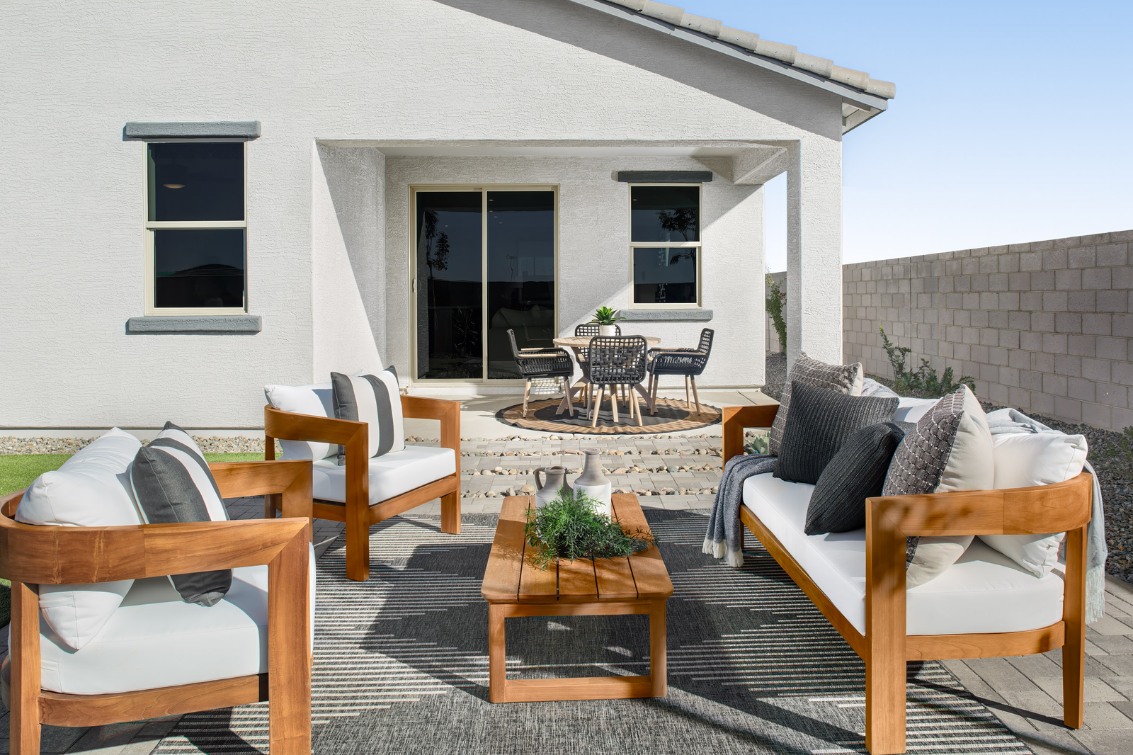 white and tan outdoor patio furniture on pavers