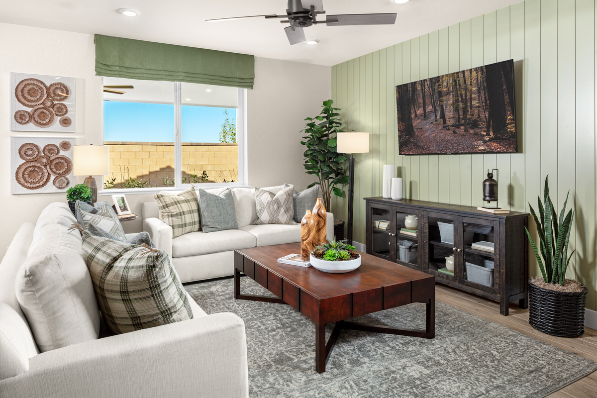great room with green wall and white couches