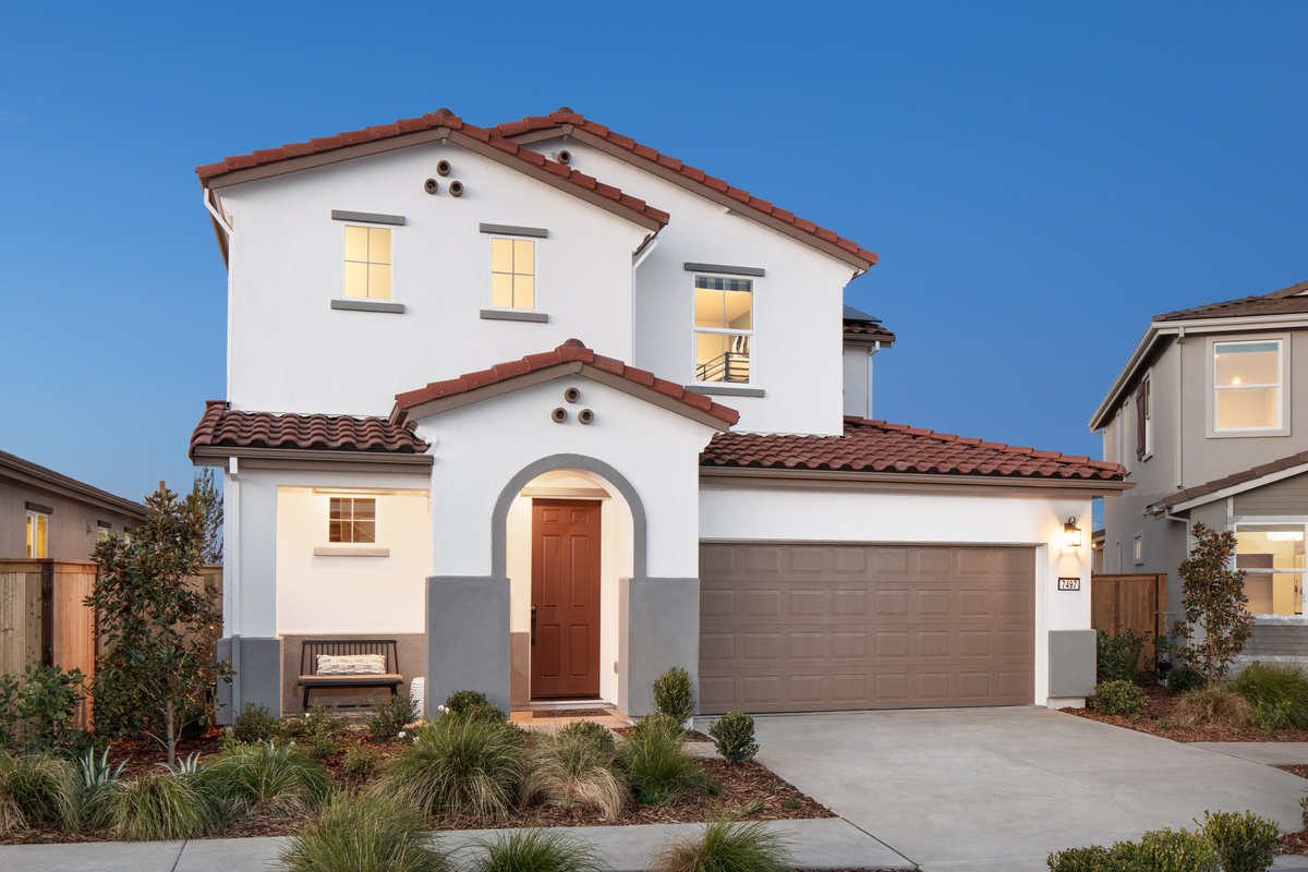 spanish style two-story home with arched entryway