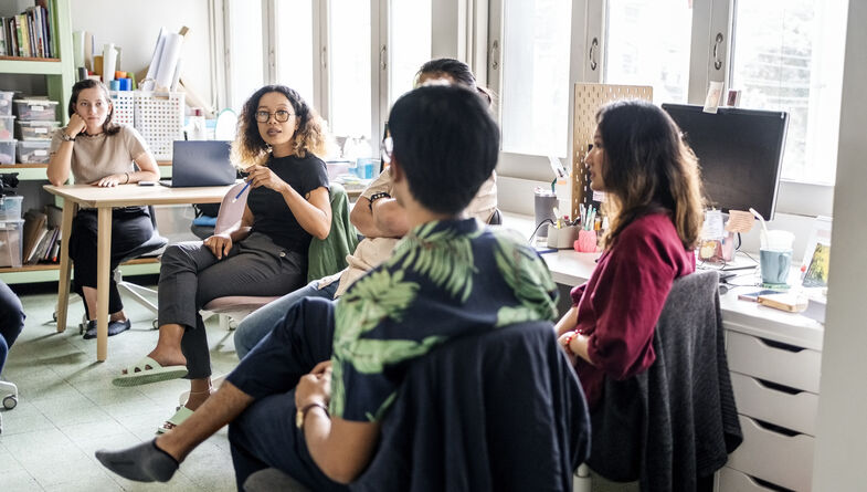 Young professionals having casual meeting in office