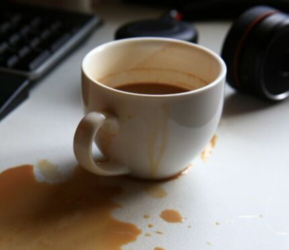 Coffee spilled on computer desk