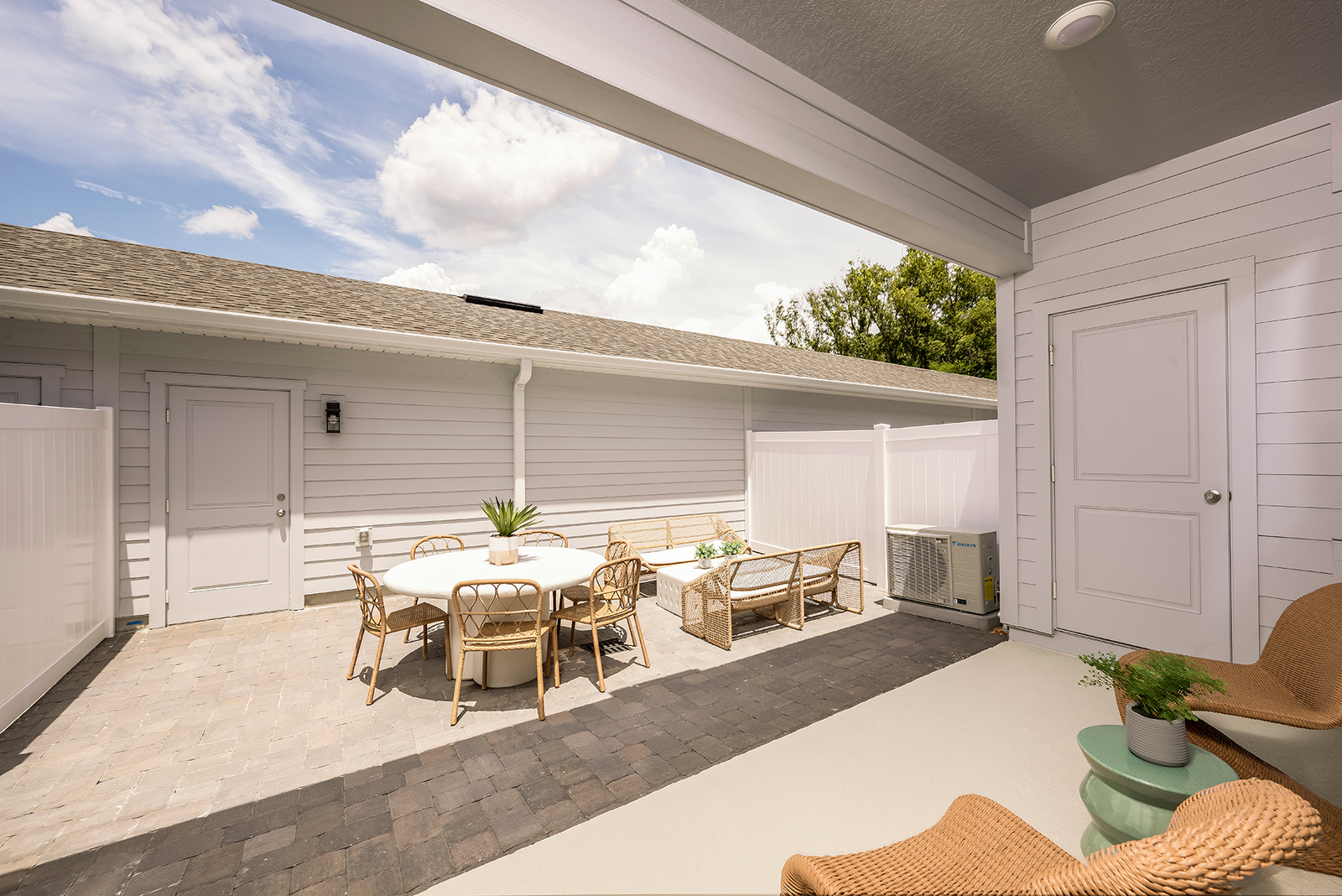 paver courtyard with white table and six chairs