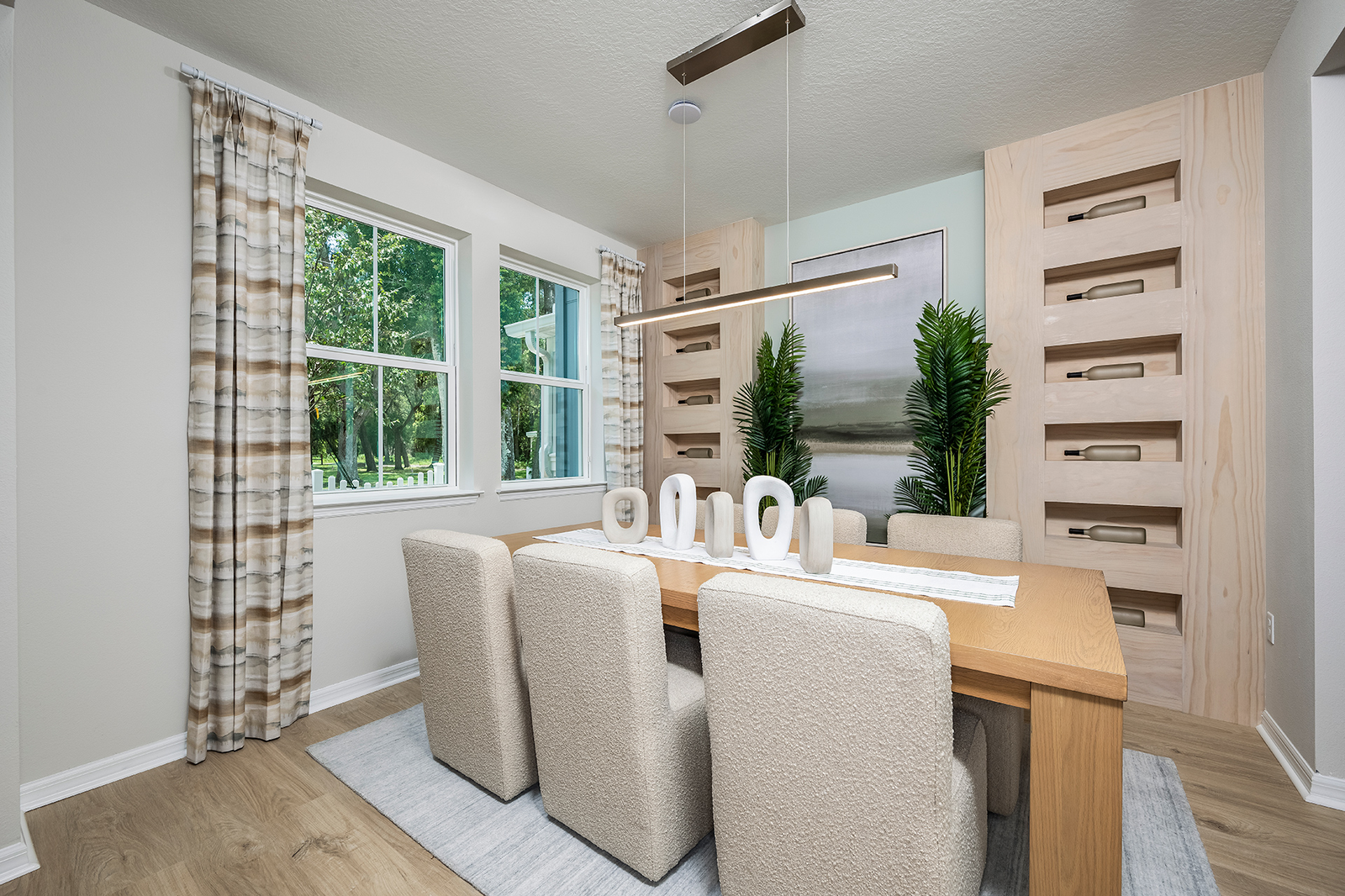 dining room with wood table and six white chairs