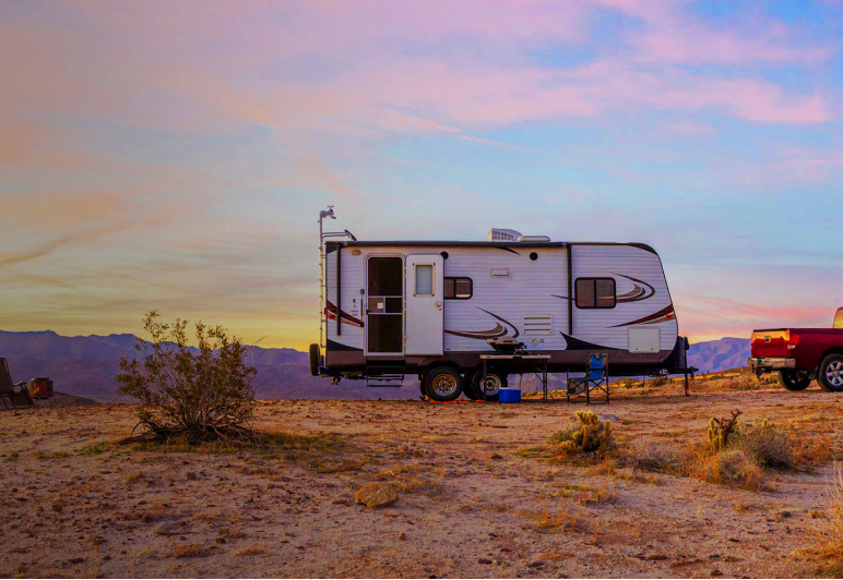 RV trailer with onboard Fathom e-power system in desert at sunset