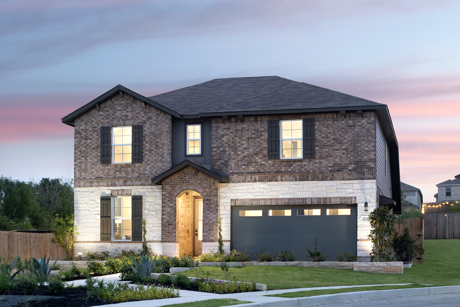 exterior with brick, stone & a covered porch 