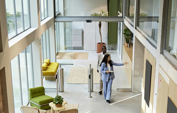 real estate agent in office lobby with clients