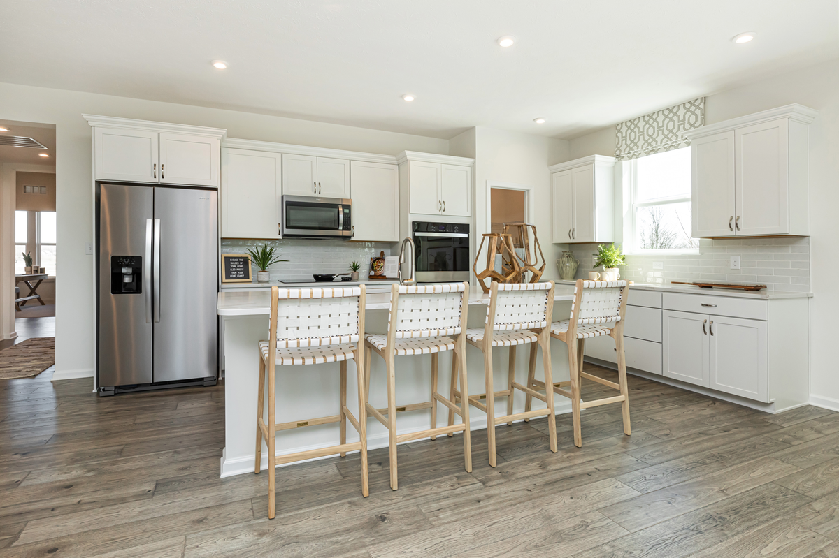 open-concept kitchen with white cabinets 