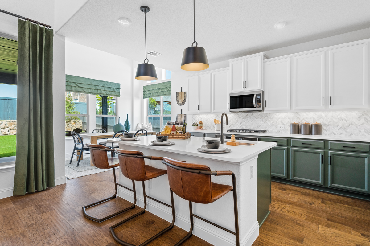 kitchen with green cabinets and dark wood floors