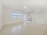 great room with tile flooring and two windows