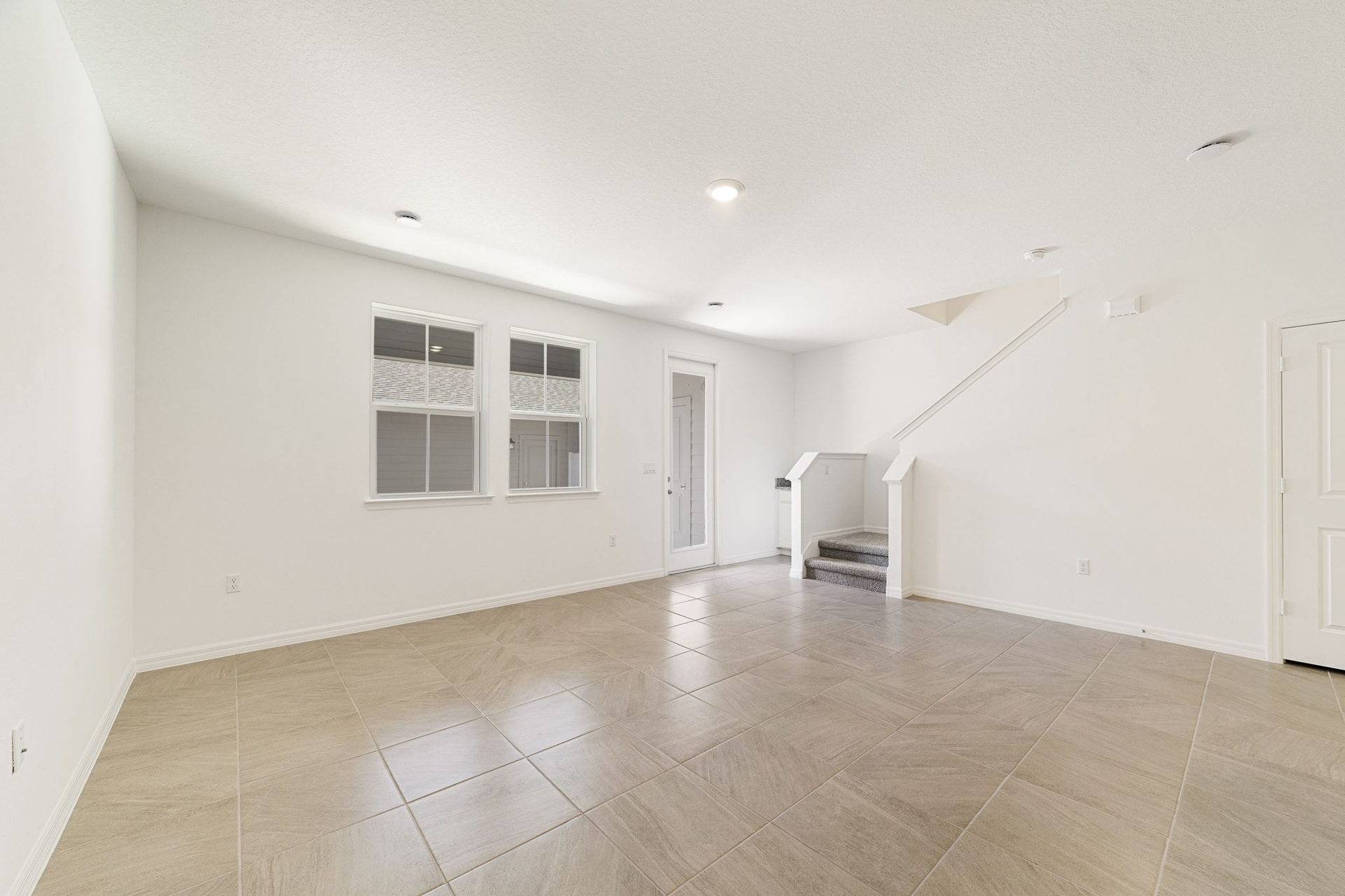room with access to the lanai and view of the kitchen